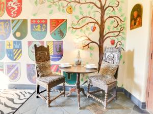 a table and two chairs in a room with a tree mural at Henrys Haunt-Rxx8 in Stanton in Peak +14 photos