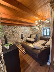 a living room with a couch and a table at Villa Darche in Vrbnik +11 photos