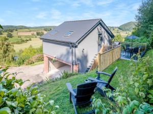 a small house with two chairs in front of it at Wye Nest in Fownhope