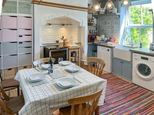 a kitchen with a table and chairs in a kitchen at Enginemans Cottage in Bishop Auckland