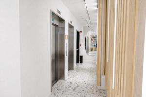 a hallway with white walls and a tile floor at Bird Nest Suites in Istanbul