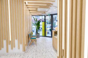 a hallway of an office with a chair and a store at Bird Nest Suites in Istanbul