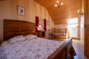 a bedroom with a large bed in a room at Digitales en margeride in SAINT DENIS EN MARGERIDE