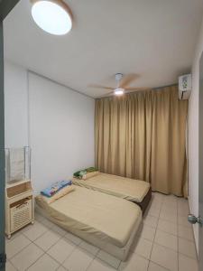 a bedroom with two beds and a ceiling fan at Condo Apartment RSS in Malacca