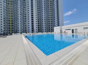 a large swimming pool in front of tall buildings at Condo Apartment RSS in Malacca