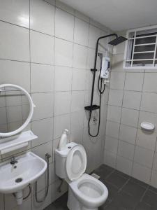 a bathroom with a shower and a toilet and a sink at Condo Apartment RSS in Malacca