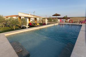a swimming pool in front of a house at Barnhouse Duplex in Idanha-a-Nova