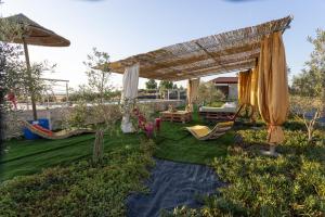 a backyard with an umbrella and chairs and a table at Barnhouse Duplex in Idanha-a-Nova