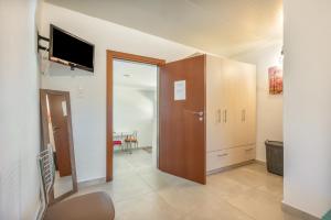 a living room with a sliding door and a television at Lydia Guest House in Palekastron