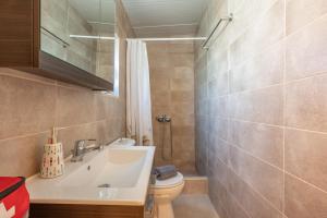 a bathroom with a sink and a toilet at Lydia Guest House in Palekastron +13 photos