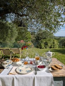a table with plates of food on it at Giardino Antico in Montecarotto +36 photos