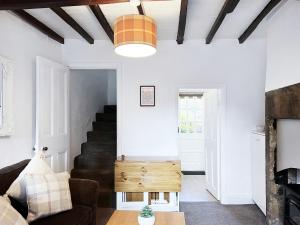 a living room with a couch and a table at The Willow Nook in Pateley Bridge +12 photos