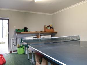 a ping pong table in a room with a ping pong table at Haddon Cottage - Uk40270 in Bakewell