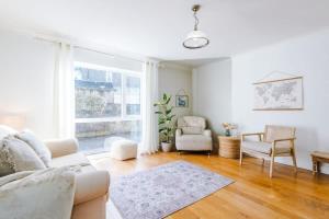 a living room with a couch and chairs and a window at Ascot House in Buxton