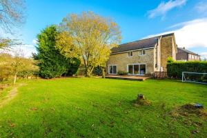 a house with a large lawn in front of it at Ascot House in Buxton