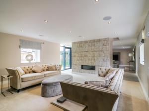 a living room with two couches and a fireplace at 15 Chivits - Ukc8971 in Warkworth