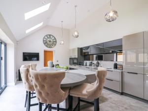 a kitchen with a round table and chairs at 15 Chivits - Ukc8971 in Warkworth