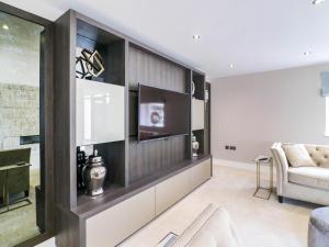 a living room with a tv and a couch at 15 Chivits - Ukc8971 in Warkworth +26 photos