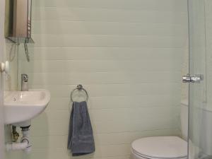 a bathroom with a toilet and a sink at Privet Pod - Uk41394 in Westhead +2 photos