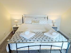 a bedroom with a bed with two night stands at Leaderfoot Cottage in Selkirk