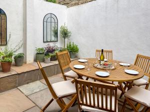 a wooden table and chairs on a patio at Stone's Throw in Richmond