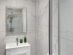 a white bathroom with a sink and a shower at Stone's Throw in Richmond