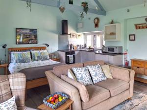 a living room with a couch and a kitchen at The Studio At Westfield in Bellingham