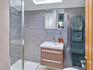 a bathroom with a shower and a sink and a toilet at The Studio At Westfield in Bellingham
