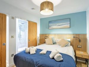 a bedroom with a large bed with towels on it at 178 Residences - Ukc8998 in Ilfracombe