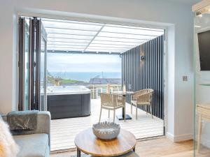 a living room with a balcony with a tub at 178 Residences - Ukc8998 in Ilfracombe