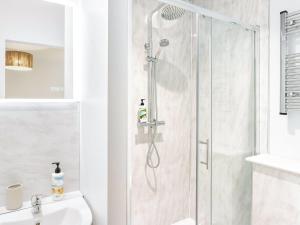 a shower with a glass door in a bathroom at 178 Residences - Ukc8998 in Ilfracombe