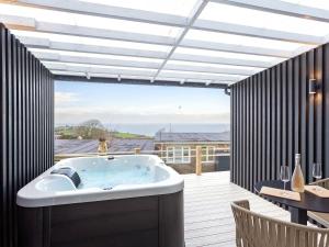 a hot tub on the deck of a house at 178 Residences - Ukc8998 in Ilfracombe +5 photos