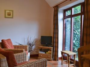 a living room with a tv on a wooden table at Dill - E4324A in Catfield