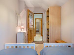 a bedroom with two beds and a closet at Pebble Cottage in Weymouth