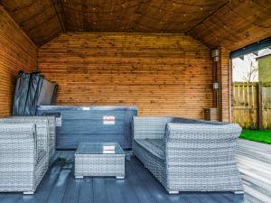 two wicker chairs and a table in a patio at 13 Shearling - Ukc8974 in Warkworth