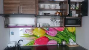 a refrigerator filled with lots of different colored vegetables at Apartament Masovia in Mrągowo