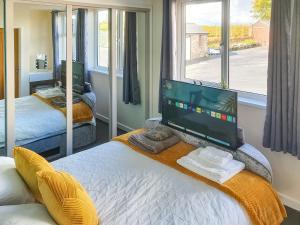 a bedroom with a bed with a television on it at Classroom Two - Uk48651 in Lifton