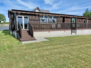 a wooden house with a porch and a deck at Classroom Two - Uk48651 in Lifton