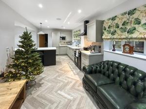 a living room with a christmas tree and a couch at Cannock Chase in Rugeley