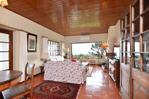 a living room with a couch and a table at Casa do Moinho in Ulgueira