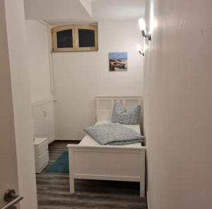 a small room with a bed and a window at Fewo-Am-alten-Bahnhof in Tangerhütte