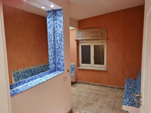 a bathroom with a shower with blue tiles at Fewo-Am-alten-Bahnhof in Tangerhütte