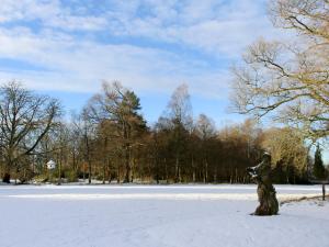 a statue of a dog standing in the snow at Gilminscroft Gatehouse in Sorn