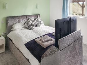 a bedroom with a bed with a tv on it at Classroom One - Uk48650 in Lifton