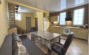 a living room with a table and a kitchen at Будинок у моря in Odesa