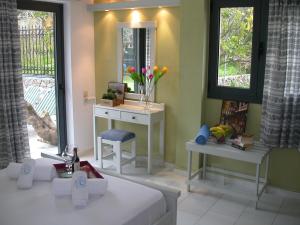 a dressing room with a table and a mirror at Terpsichori villa and apartments in Kalamaki Chanion