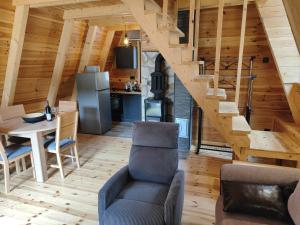 a living room with a staircase in a wooden house at Villa Moonlight,Žabljak in Žabljak