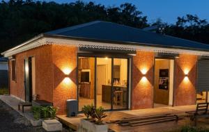 a small house with lights on the side of it at Villa Aloa Private pool in Les Abymes