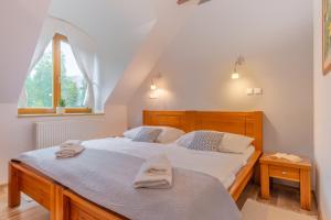 a bedroom with two beds with towels on them at Central Apartmany in Starý Smokovec