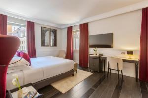 a hotel room with a bed and a desk and a television at Palazzo Navona Hotel in Rome +36 photos